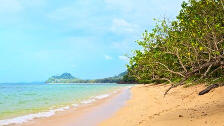 sunny beach and island on horizon, Thailandの写真素材