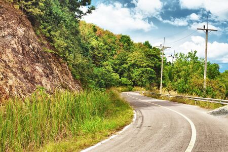 asphalt highway in jungle, Koh Lanta Noi, Thailandの写真素材