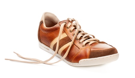 brown leather trainer shoe isolated on whiteの写真素材