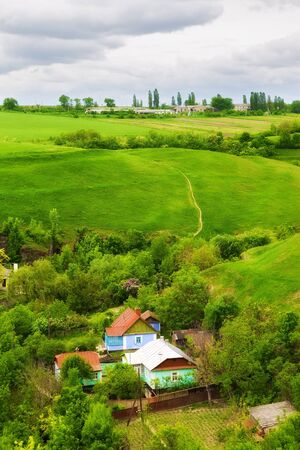 landscape with farm and green meadow, high angle viewの写真素材