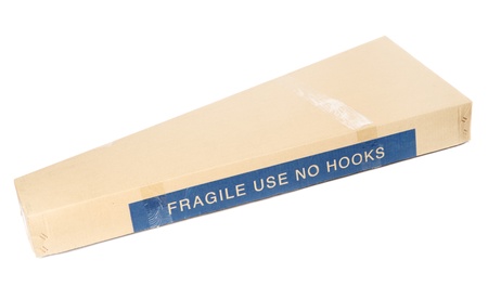 closed triangular cardboard box isolated on whiteの写真素材