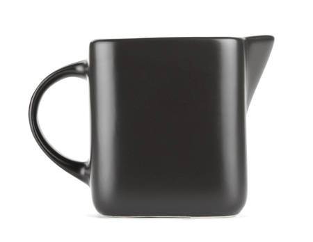 empty quadratic pitcher jug for milk isolated on whiteの写真素材