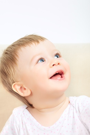 beautiful laughing baby with blue eyes portraitの写真素材