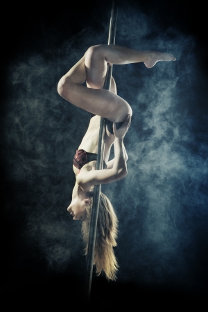 young sexy pole dance woman, dark backgroundの写真素材