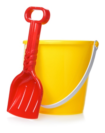 yellow toy bucket and red scoop, isolated on whiteの写真素材