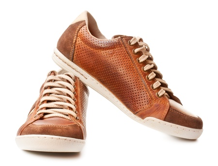 brown leather trainer shoe isolated on whiteの写真素材