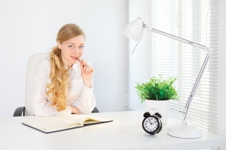 portrait of smiling office girl working at deskの写真素材