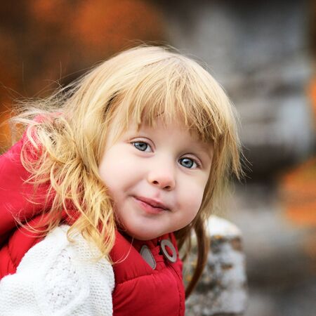 beautiful little girl in autumn park, portraitの写真素材