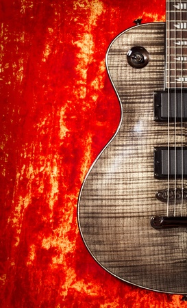 black electric guitar on red velvet backgroundの写真素材