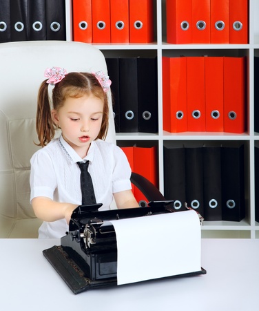 little girl as a businesswoman, in officeの写真素材