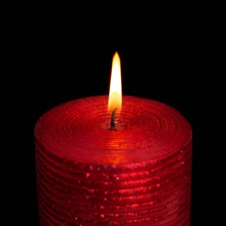 burning wax candle on a black backgroundの写真素材