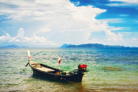 traditional thai long boat on beach in Thailandの写真素材