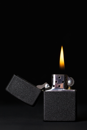 black gasoline lighter with flameの写真素材