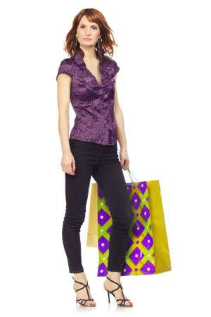 happy girl with shopping bags, isolated on whiteの写真素材