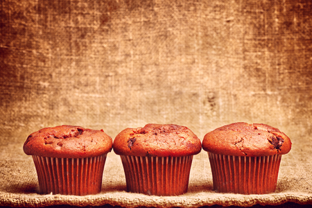 fresh chocolate muffin, on brown canvas backgroundの写真素材