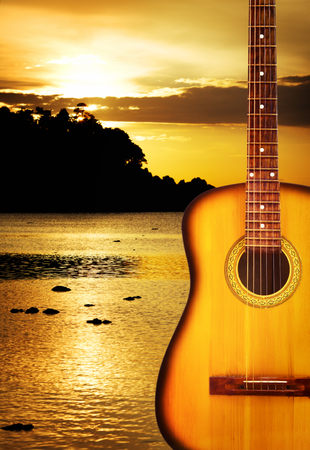 yellow classic acoustic guitar, on nature backgroundの写真素材