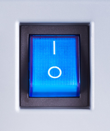 blue power switch button turned on, close upの写真素材
