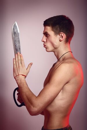 young handsome man with machete in hand