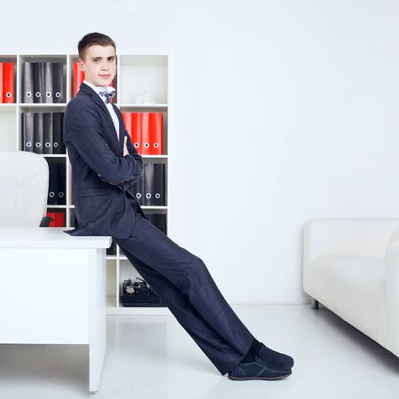 confident young handsome businessman in his officeの写真素材