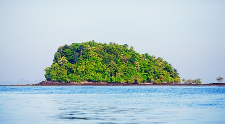 tall island with trees at Andaman Sea, Thailandの写真素材