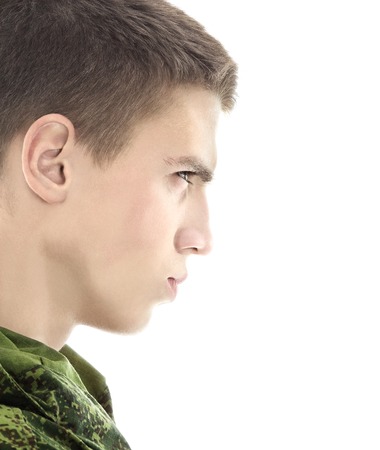 young military man profile, closeup portrait isolated on whiteの写真素材