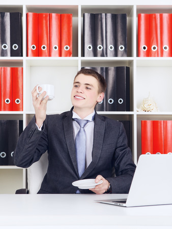 young businessman with laptop in his officeの写真素材