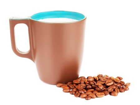 brown mug with cappuccino and coffee beans, isolated on whiteの写真素材