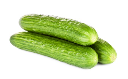 three fresh long cucumbers, isolated on white backgroundの写真素材