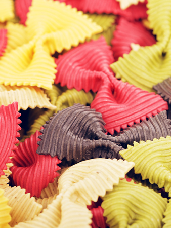 raw bow-knot pasta of different color, backgroundの写真素材