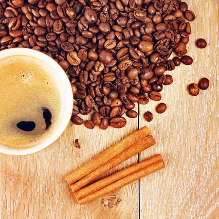 cup of espresso and coffee beans on wooden tableの写真素材