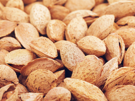 fresh raw unpeeled almonds nuts, food backgroundの写真素材