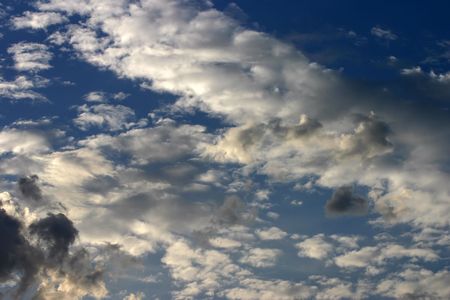 Dramatic evening cloudscape with white and gray clouds