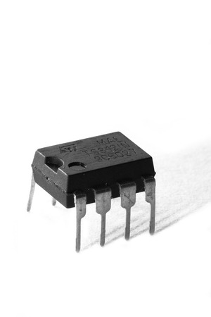 Black and white macro shot of an electronic device, isolated on white (operational amplifier)