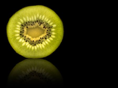 Kiwi slice isolated on black with reflectionの写真素材