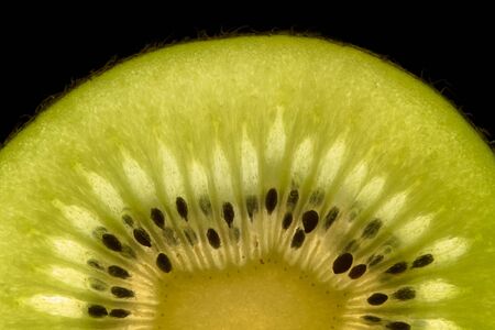 Half kiwi slice isolated on blackの写真素材