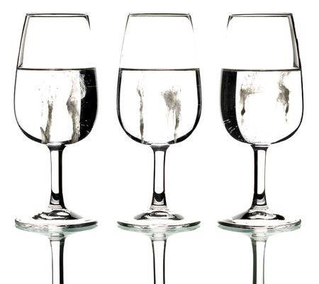 Silhouette of three glasses containing a creamy splatterの写真素材