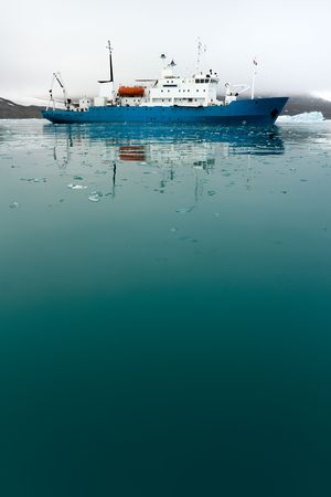 Icebreaker in icy water.  Vertically framed shot.の写真素材