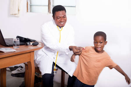 Before the consultationthe pediatrician consoles the child by giving him a candyの写真素材