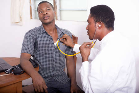 At the doctor, the doctor listens the patientâs heartbeatの写真素材