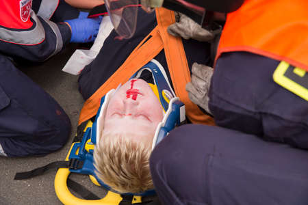 Aachen (Germany) july 09, 2017. Ambulance service 1. Paramedics are  preparing an injured person for the transport to the nearby hospitalのeditorial素材