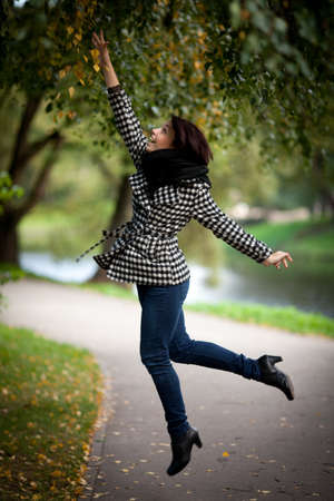 Beautiful girl jumping in a parkの写真素材
