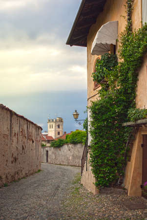 Narrow road between the old houses of the town of Saluzzoの写真素材
