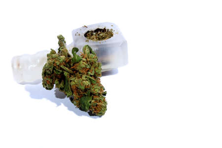 Isolated marijuana bud laying by a pipe  の写真素材