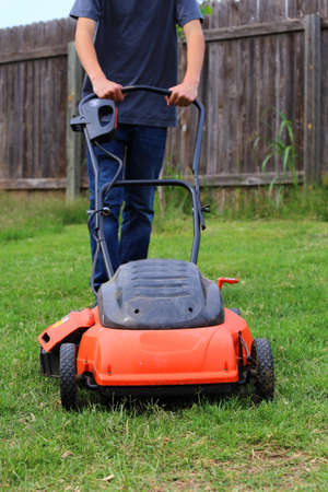Close up view of someone mowing the lawn