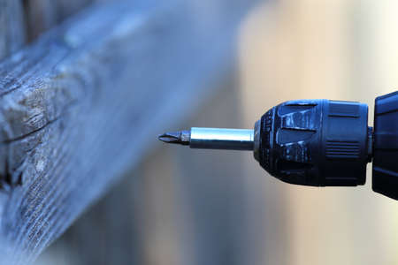 A close up view of someone holding an electric drill