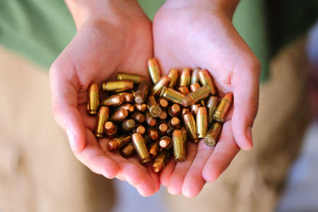 A close up view of someone holding 380 caliber bullets
