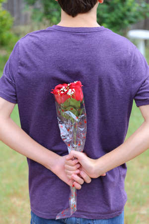 Someone Holding roses behind their backの写真素材