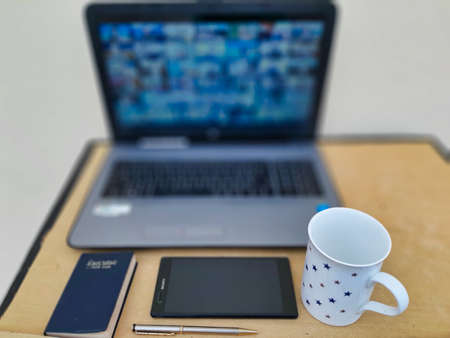 Jaipur,India-Circa 2020:Picture of a laptop and other office related objects kept on a table. Work...