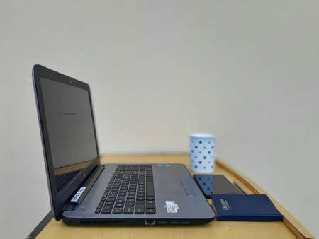 Jaipur,India-Circa 2020: Picture of laptop and other office related objects kept on a desk. Work is being done from home.のeditorial素材