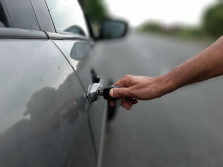 Picture of a person unlocking his car with keyの写真素材